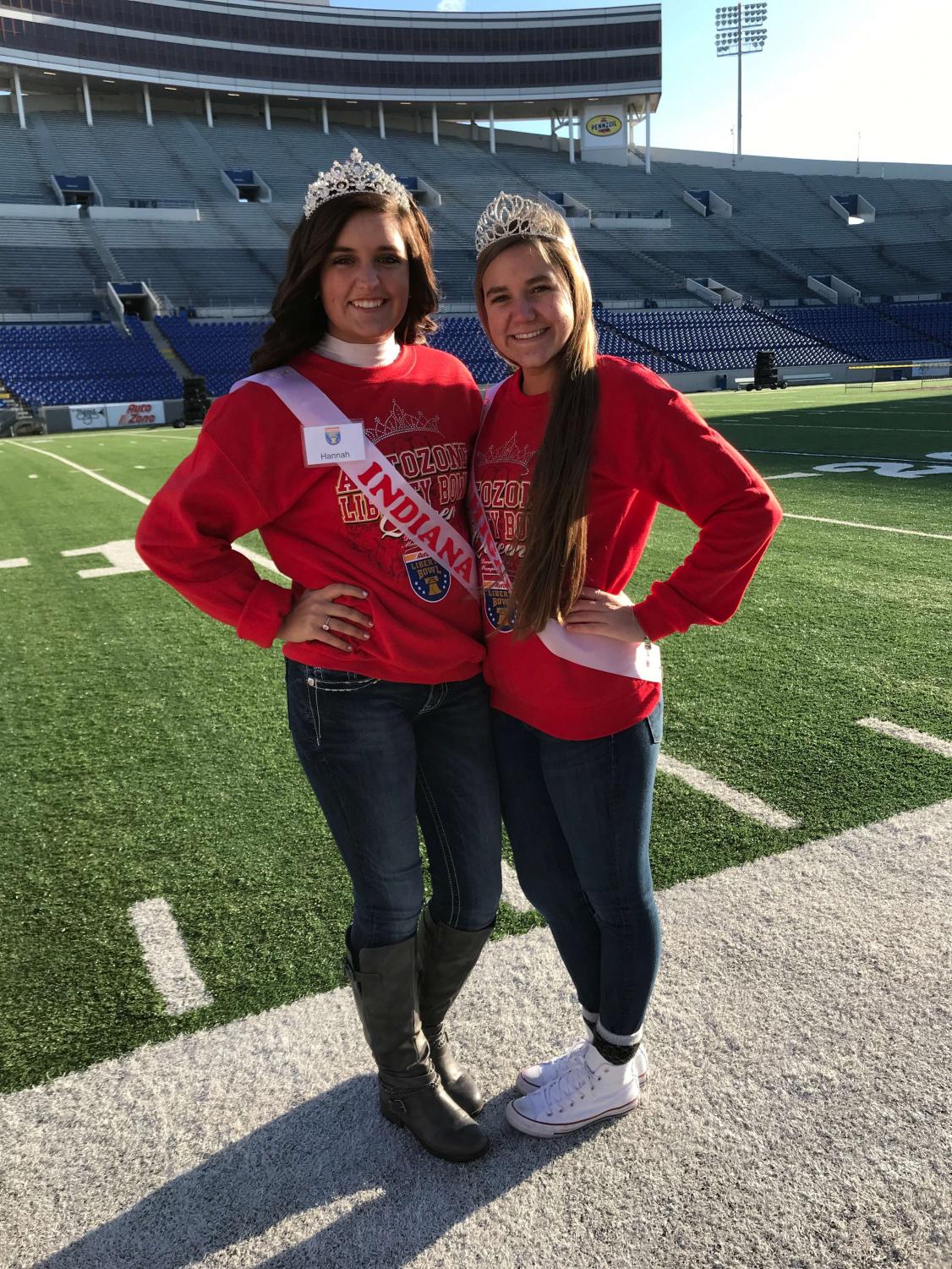 Michigan rep. Maddy Ippel (right) and Indiana rep. Hannah Behm (left) on the field at the 2017 AutoZone Liberty Bowl in Memphis, Tennessee.